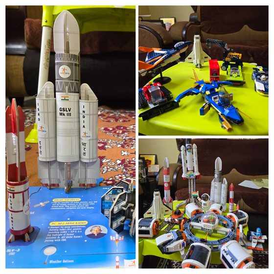 Vrishvardhan Sharma beside full scale ISRO launch vehicle models in a space gallery.