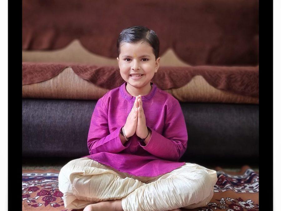 Vrishvardhan Sharma seated cross legged with his palms joined.